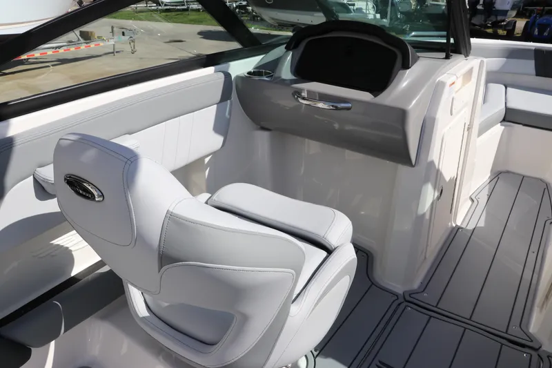 Slide: The Image of 2026 Chaparral 21 SSi OB boat interior with sleek seating and modern dashboard design. - 24