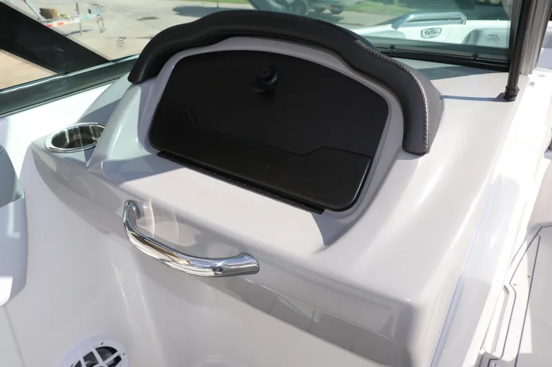 Slide: The Image of 2026 Chaparral 21 SSi OB boat dashboard with storage compartment and cup holder. - 26