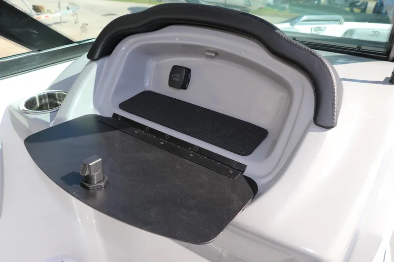 Slide: The Image of 2026 Chaparral 21 SSi OB boat dashboard storage compartment with cup holder. - 27