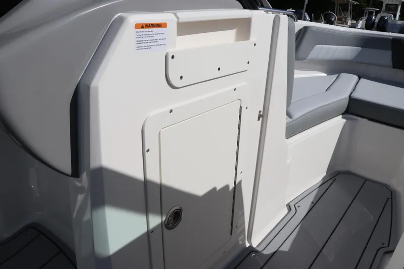 Slide: The Image of Interior view of 2026 Chaparral 21 SSi OB boat, featuring seating and storage compartment. - 29