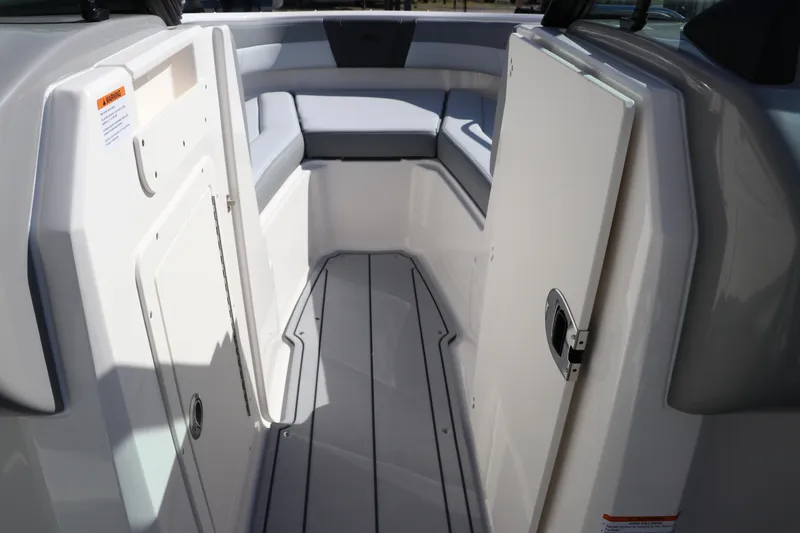 Slide: The Image of 2026 Chaparral 21 SSi OB boat interior with seating and storage compartments. - 31