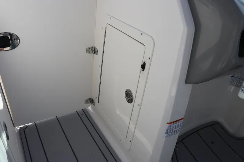 Slide: The Image of Interior view of 2026 Chaparral 21 SSi OB boat, featuring a storage compartment. - 34