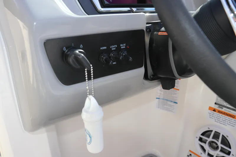 Slide: The Image of Dashboard controls of 2026 Chaparral 21 SSi OB boat with ignition key and switches. - 41