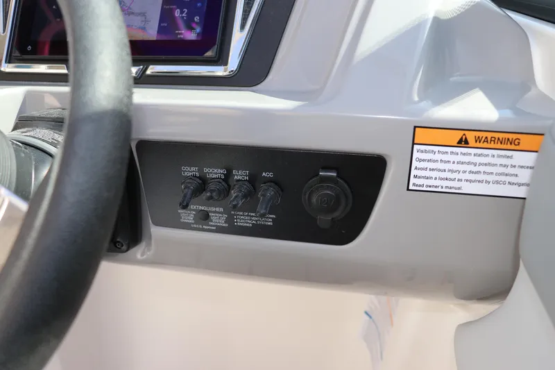 Slide: The Image of Control panel of 2026 Chaparral 21 SSi OB boat with warning label and switches. - 42