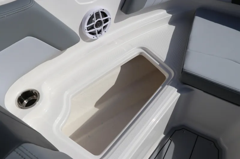 Slide: The Image of Interior storage compartment of 2026 Chaparral 21 SSi OB boat with speaker and cup holder. - 44