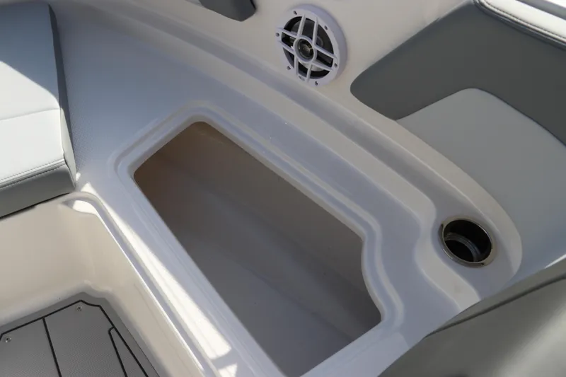 Slide: The Image of 2026 Chaparral 21 SSi OB boat interior with storage compartment and speaker. - 45