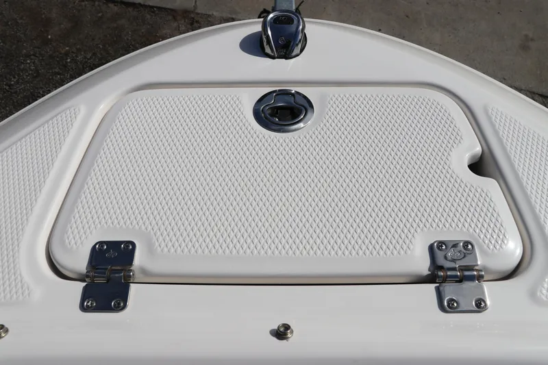 Slide: The Image of Bow storage hatch on 2026 Chaparral 21 SSi OB boat, featuring textured surface and stainless steel hinges. - 48