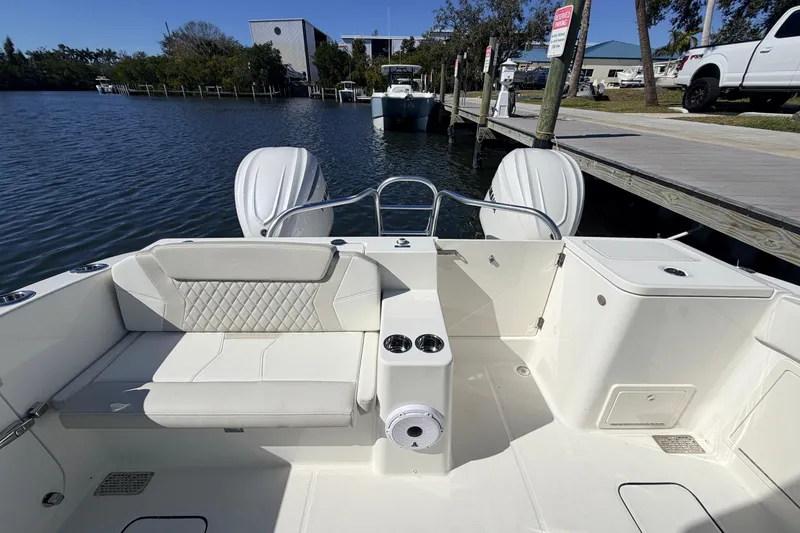 Slide: The Image of 2026 World Cat 325 DC boat interior with seating and dual engines at a dock. - 10