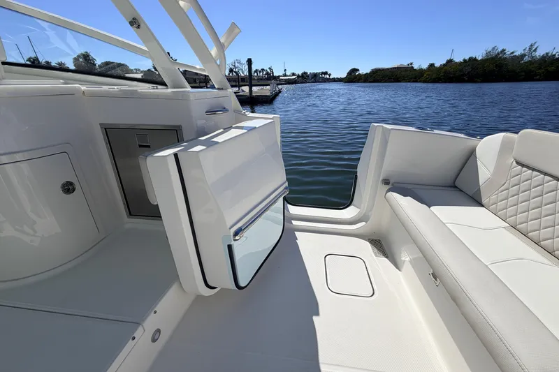Slide: The Image of 2026 World Cat 325 DC boat interior with luxurious seating and water view. - 12