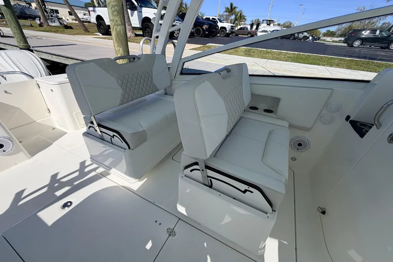Slide: The Image of 2026 World Cat 325 DC boat interior with white seating and modern design. - 15