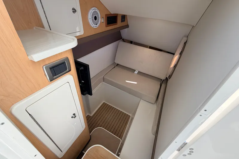 Slide: The Image of Interior cabin of 2026 World Cat 325 DC boat, featuring seating and storage. - 17