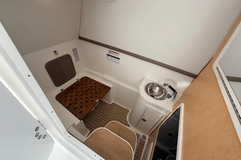 Slide: The Image of 2026 World Cat 325 DC interior cabin with sink and wooden seating. - 18