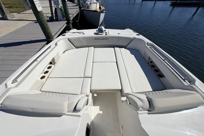 Slide: The Image of 2026 World Cat 325 DC boat with spacious white seating at the dock. - 19