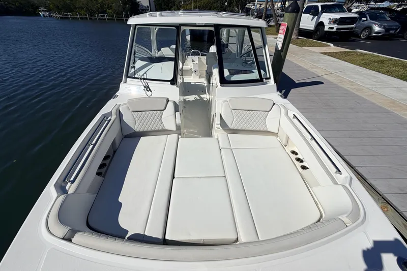 Slide: The Image of 2026 World Cat 325 DC boat with spacious seating, docked by the water. - 20