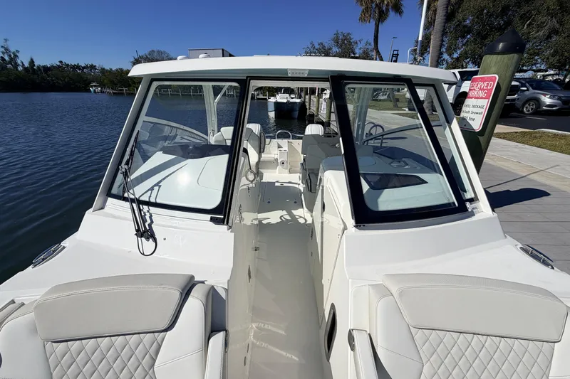 Slide: The Image of 2026 World Cat 325 DC boat docked, featuring sleek design and spacious seating. - 22