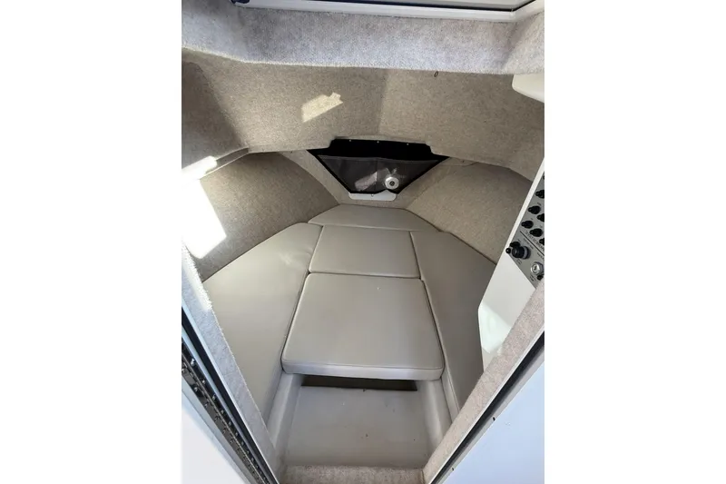 Slide: The Image of 2024 Parker 2520 XLD Sport Cabin interior with cushioned seating and carpeted walls. - 10