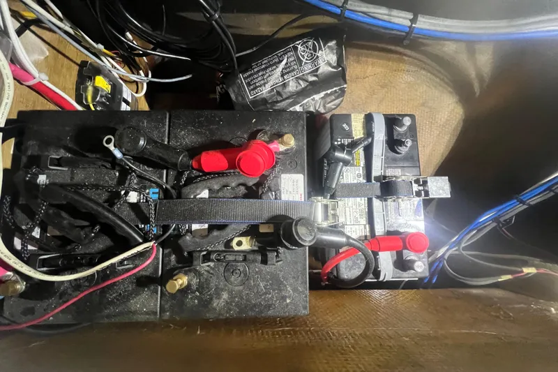 Slide: The Image of Battery compartment of a 1999 Southern Cross Cutter with wiring and connections. - 17