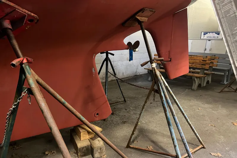 Slide: The Image of 1999 Southern Cross Cutter sailboat hull on stands in a workshop. - 18