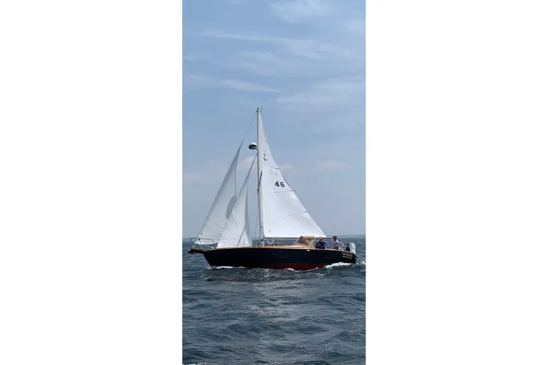 Slide: The Image of Sailing on open water, 1999 Southern Cross Cutter with white sails and blue hull. - 28