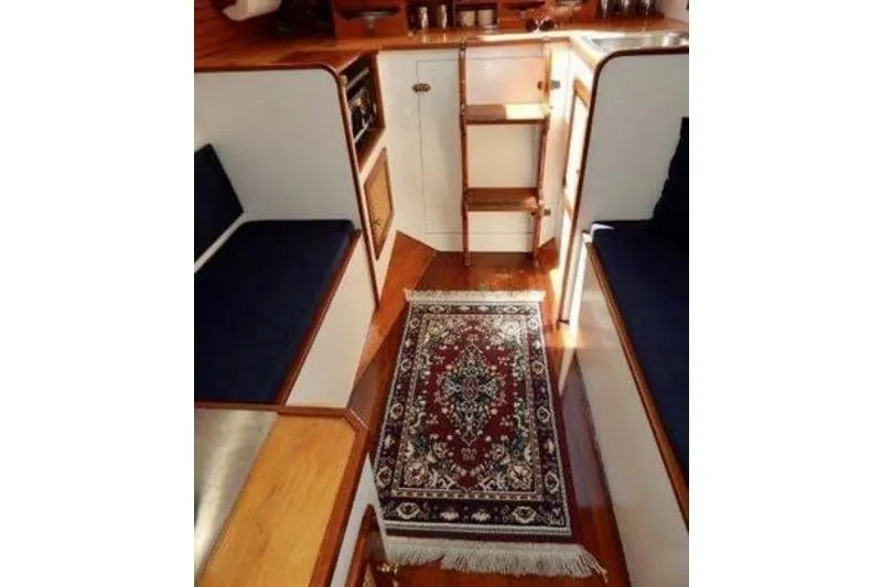 Slide: The Image of Interior of 1999 Southern Cross Cutter with elegant rug and wooden finishes. - 4