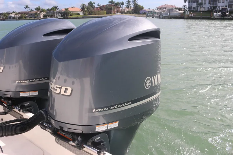 Slide: The Image of 2019 Cobia 280 Dual Console storage compartment with open hatch, showcasing interior details. - 17