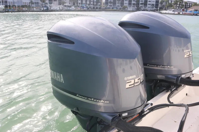Slide: The Image of 2019 Cobia 280 Dual Console boat interior with seating and table on open water. - 18