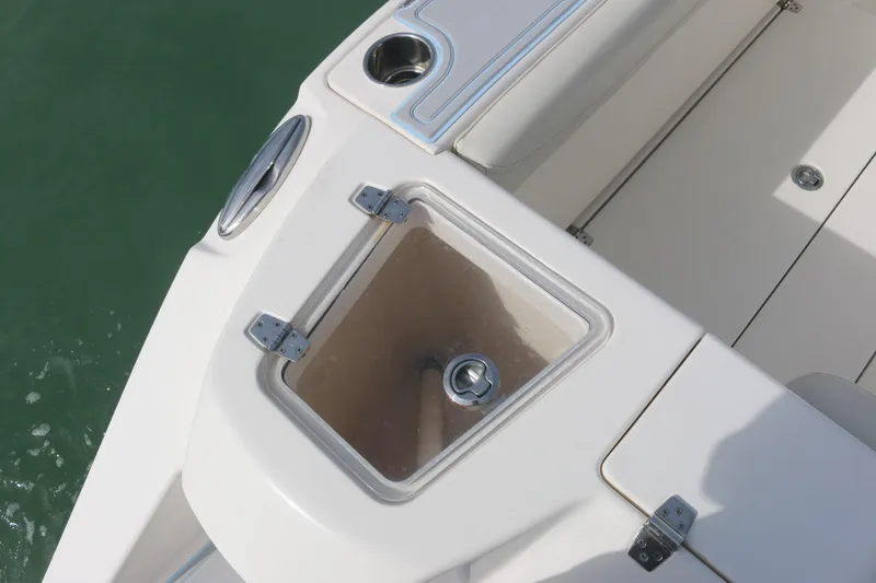 Slide: The Image of 2019 Cobia 280 Dual Console boat with open canopy under a partly cloudy sky. - 19
