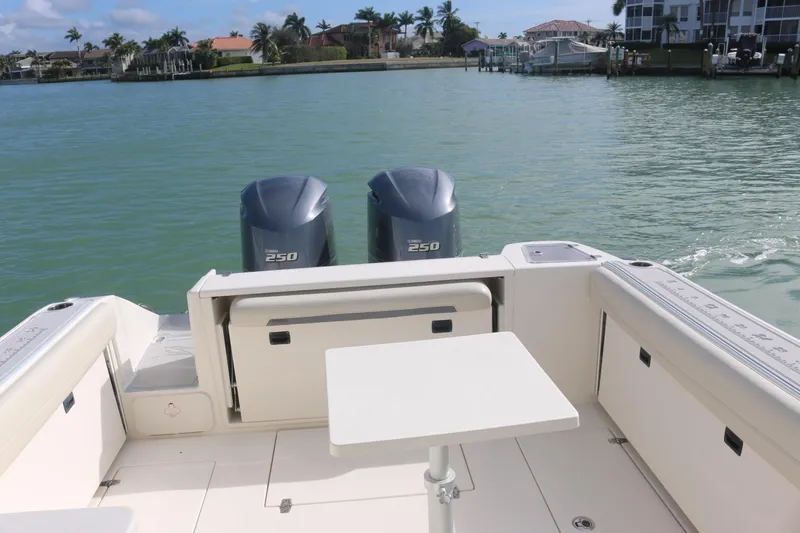 Slide: The Image of 2019 Cobia 280 Dual Console boat interior with seating and ocean view. - 20