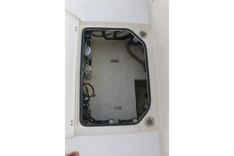 Slide: The Image of 2019 Cobia 280 Dual Console boat interior with seating, under a clear blue sky. - 22