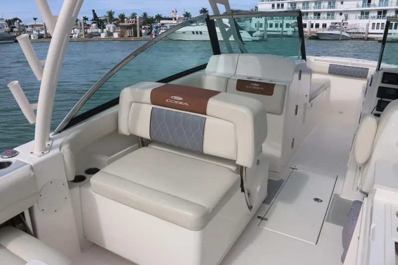 Slide: The Image of 2019 Cobia 280 Dual Console boat interior with steering wheel and cushioned seat. - 25