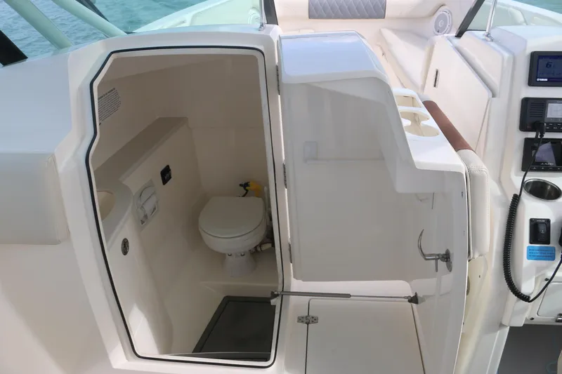 Slide: The Image of 2019 Cobia 280 Dual Console boat interior with waterfront view. - 29
