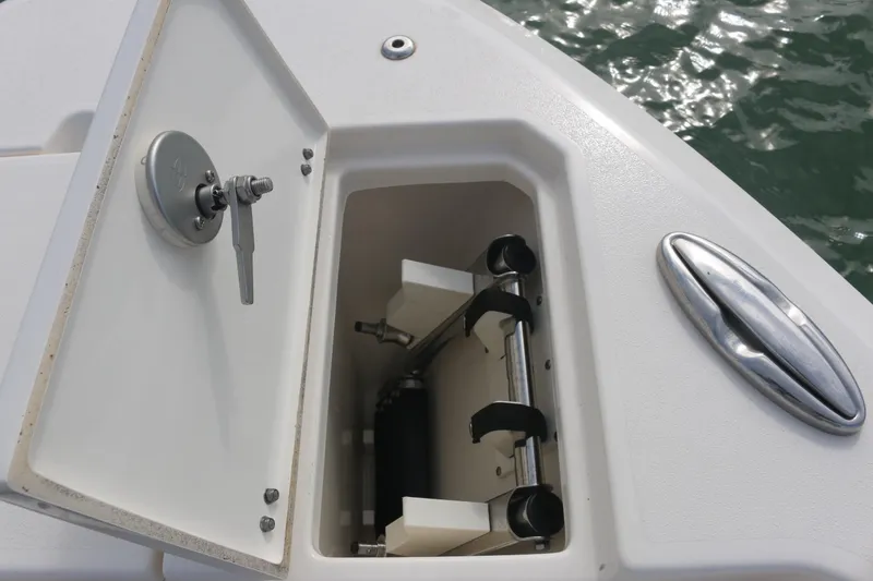 Slide: The Image of 2019 Cobia 280 Dual Console boat docked, featuring spacious seating and sleek design. - 31