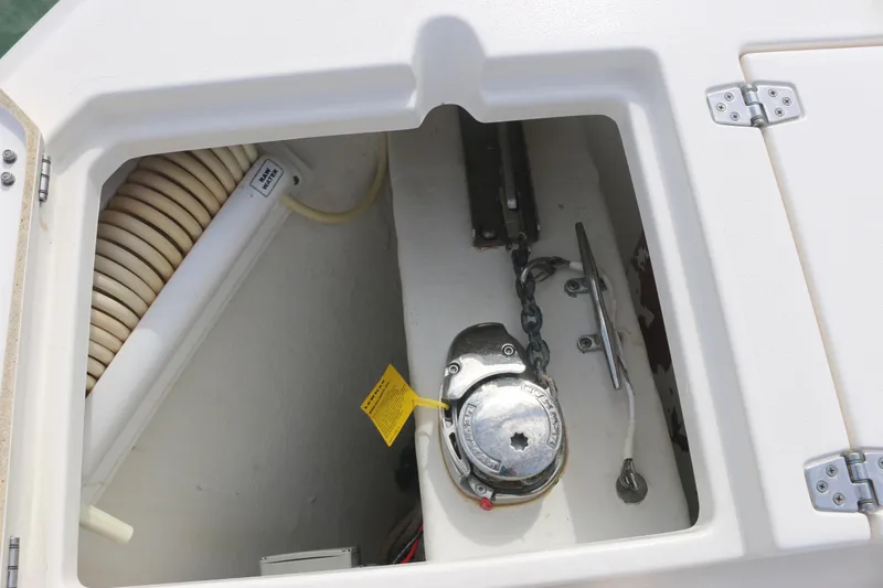 Slide: The Image of 2019 Cobia 280 Dual Console boat with open storage compartments on deck. - 32