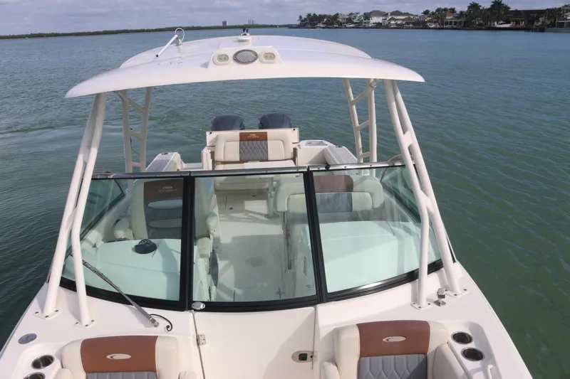 Slide: The Image of Open storage compartment on 2019 Cobia 280 Dual Console boat, near water. - 33