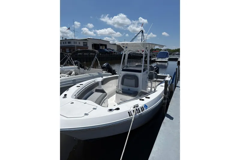 The Image of 2024 NauticStar 222L Offshore boat docked under a sunny sky. - 1