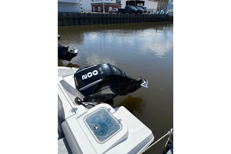 Slide: The Image of 2024 NauticStar 222L Offshore boat with Mercury 200 V6 engine docked by the water. - 10
