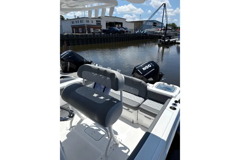 Slide: The Image of 2024 NauticStar 222L Offshore boat interior with seating and Mercury outboard motor. - 6