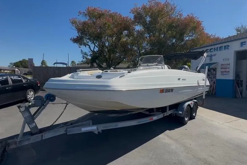 The Image of 2019 Hurricane SunDeck 237 OB boat on trailer in parking lot. - 0