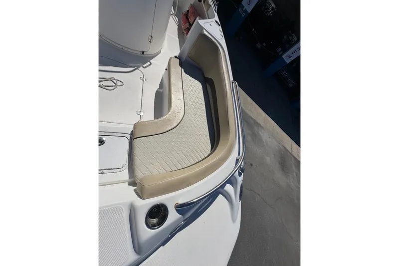 Slide: The Image of 2019 Hurricane SunDeck 237 OB boat interior with cushioned seating and stainless steel rail. - 5