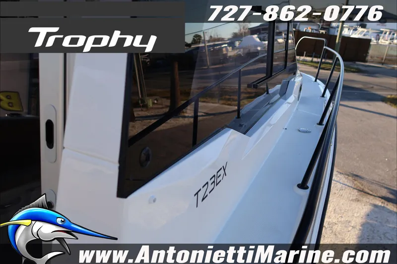 Slide: The Image of 2026 Bayliner Trophy T23 Explorer boat side view with contact details and website. - 13