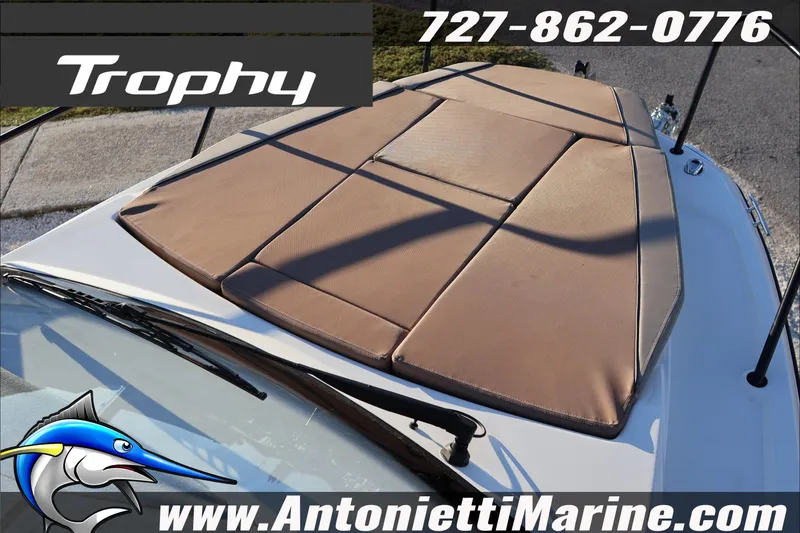 Slide: The Image of 2026 Bayliner Trophy T23 Explorer boat with cushioned deck, contact info, and website. - 14