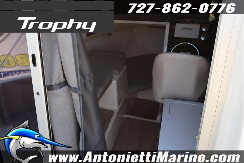 Slide: The Image of 2026 Bayliner Trophy T23 Explorer cabin interior with seating and helm, Antonietti Marine branding. - 18