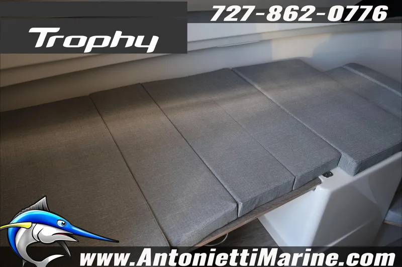 Slide: The Image of 2026 Bayliner Trophy T23 Explorer interior seating, gray cushions, Antonietti Marine contact details. - 19