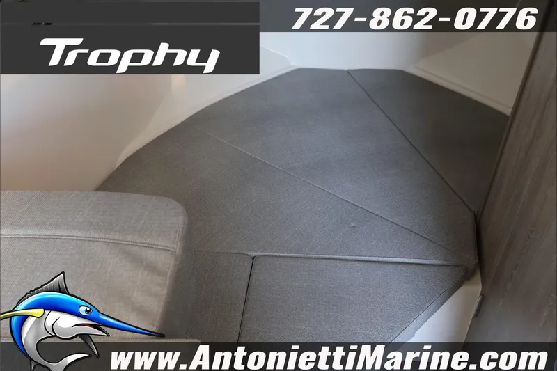 Slide: The Image of 2026 Bayliner Trophy T23 Explorer interior with gray upholstery, showcased by Antonietti Marine. - 20
