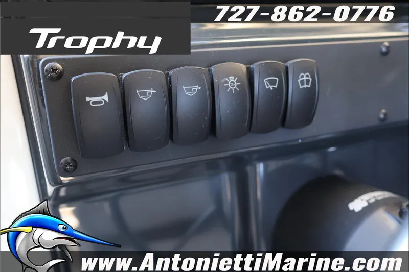Slide: The Image of Control panel of 2026 Bayliner Trophy T23 Explorer boat with various switches. - 28