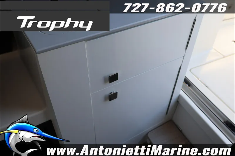 Slide: The Image of 2026 Bayliner Trophy T23 Explorer interior detail with cabinetry, featuring Antonietti Marine branding. - 36