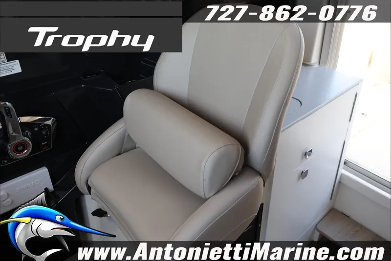 Slide: The Image of 2026 Bayliner Trophy T23 Explorer boat interior with captain's chair and control panel. - 42