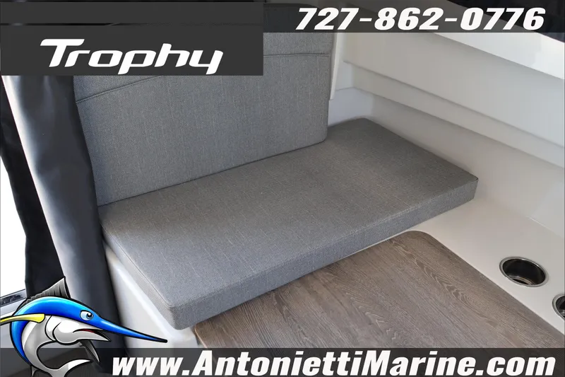 Slide: The Image of 2026 Bayliner Trophy T23 Explorer interior seating with gray upholstery and wood flooring. - 44