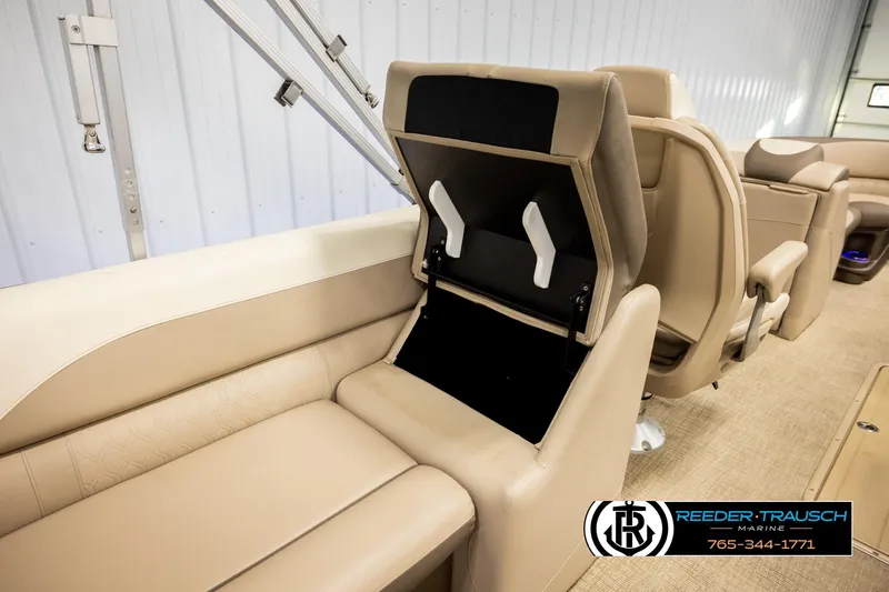 Slide: The Image of 2022 Avalon LSZ QL boat interior with beige seating and storage compartment open. - 26