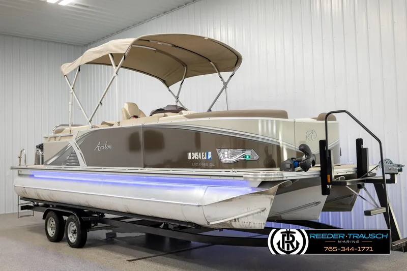 Slide: The Image of 2022 Avalon LSZ QL pontoon boat on trailer in indoor showroom. - 3